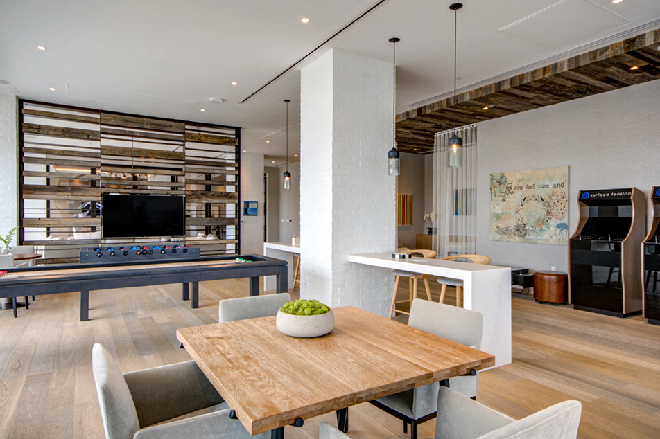 a dining room and living room with a table and a piano
